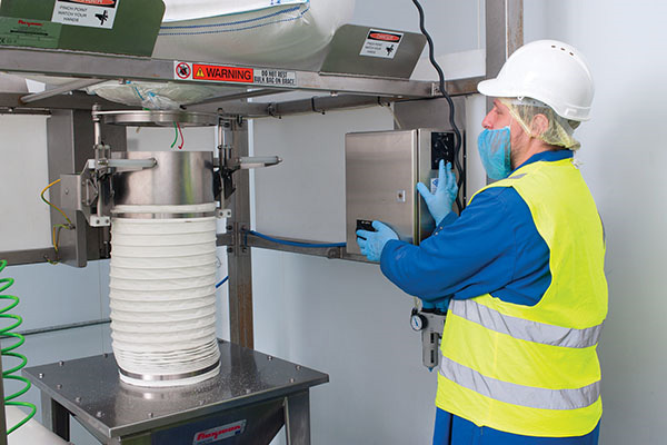Here, the operator pneumatically raises the TELE-TUBE™ telescoping tube prior to securing the bag spout using a SPOUT-LOCK™ clamp ring.